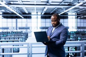 Software developer in data center implementing backup solutions